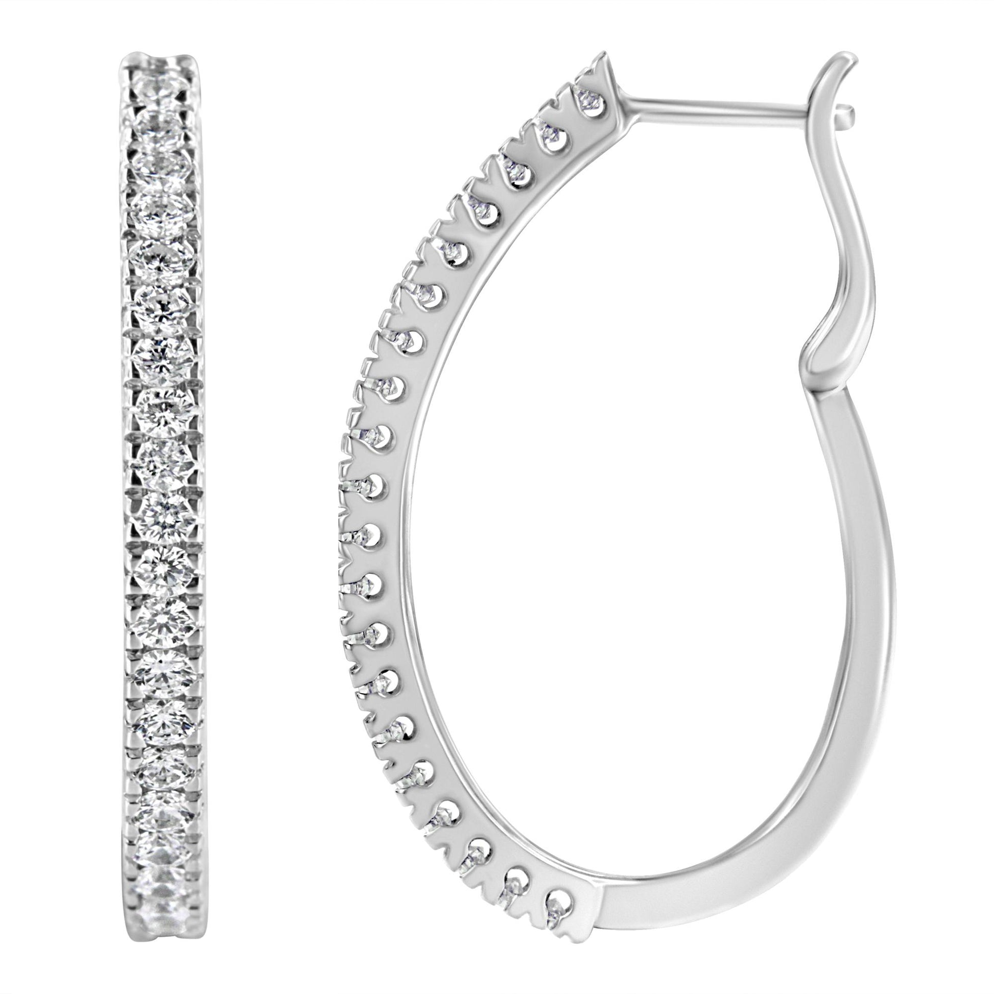 Close-up front and side views of white metal hoop earrings with round white gemstones in pave setting.