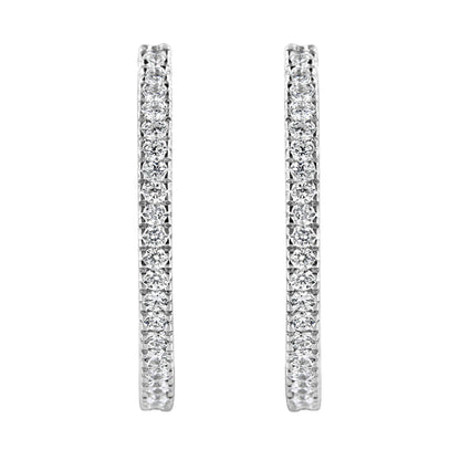 Front-facing close-up of a pair of white metal hoop earrings with round white gemstones in a pave setting.