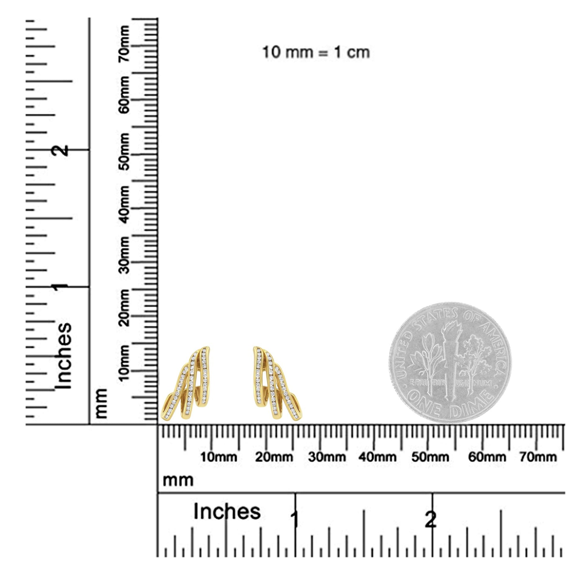 Front view of yellow metal earrings with multiple curved bars, each set with channel-set round white gemstones, shown on a ruler and a dime for size reference.