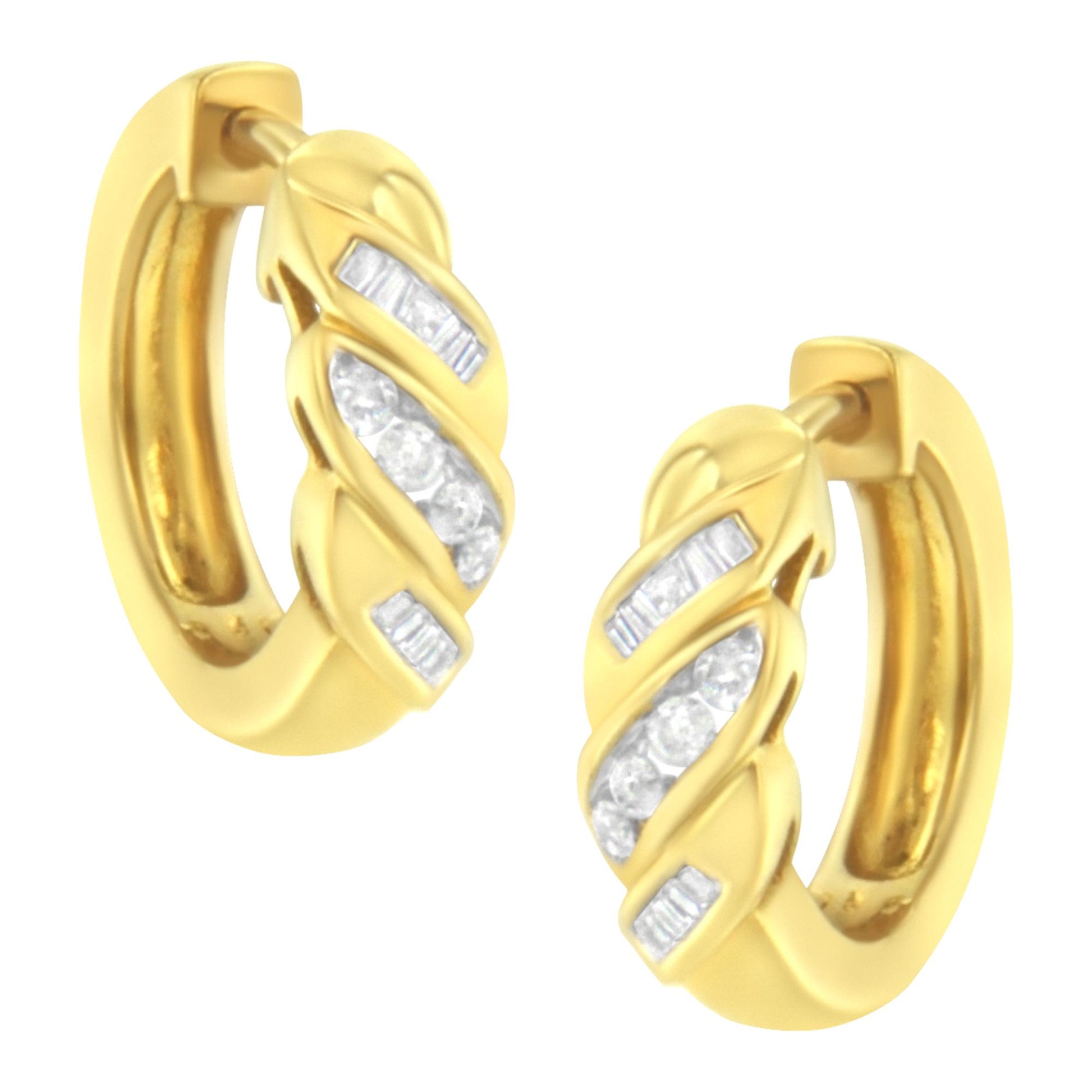 Pair of yellow metal hoop earrings with channel-set white round and baguette gemstones, front angled view.