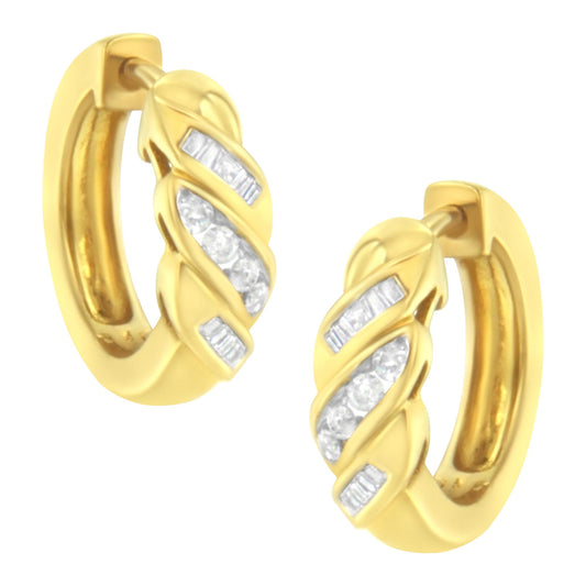 Pair of yellow metal hoop earrings with channel-set white round and baguette gemstones, front angled view.
