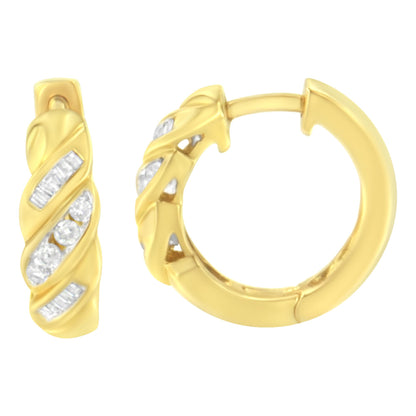 Close-up front and side view of yellow metal hoop earrings with alternating channel-set white round and baguette gemstones in a twisted design.