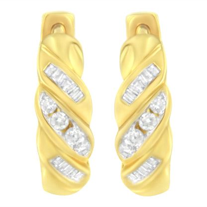 Pair of yellow metal earrings with channel-set white round and baguette-shaped gemstones, shown from a front angle.