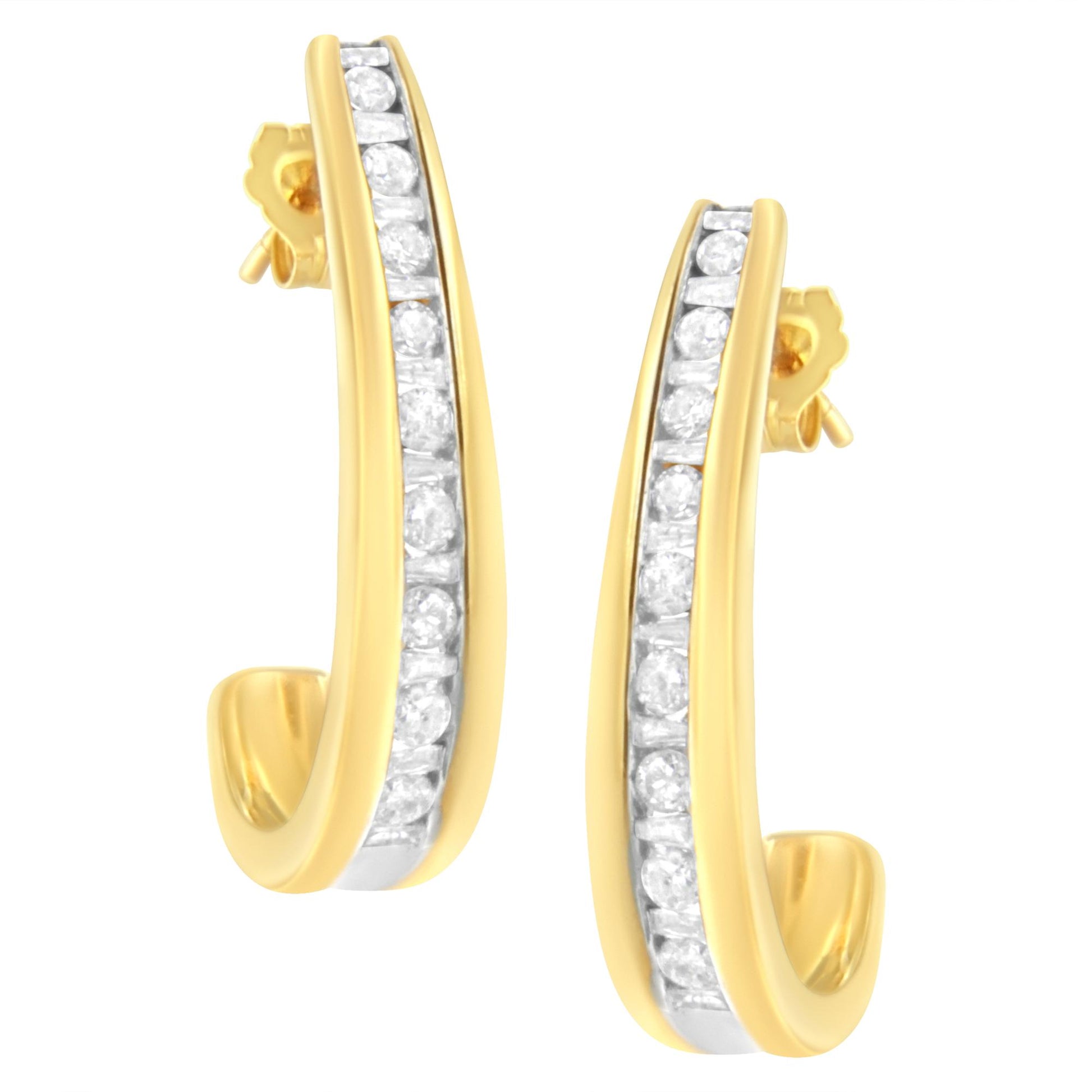Pair of yellow metal earrings with curved design, featuring channel-set white round and baguette shape gemstones, shown in a close-up front angle.