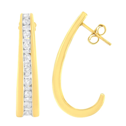 Close-up front and side view of yellow metal earrings with channel set white round and baguette shaped gemstones.