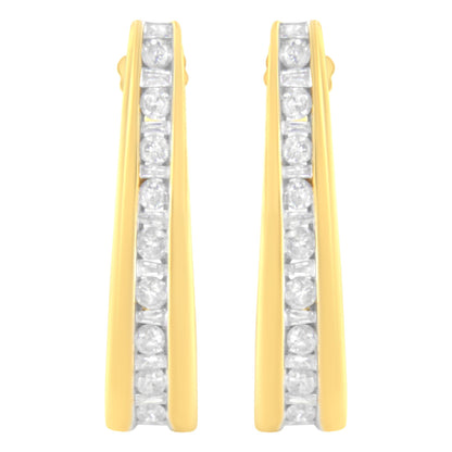Front view of a pair of yellow metal earrings with alternating round and baguette shape white gemstones set in a channel setting along the center.