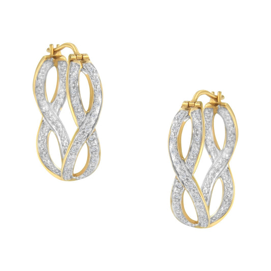 Close-up front angle view of a pair of yellow metal earrings with an intertwined design, featuring two rows of prong-set round white gemstones.