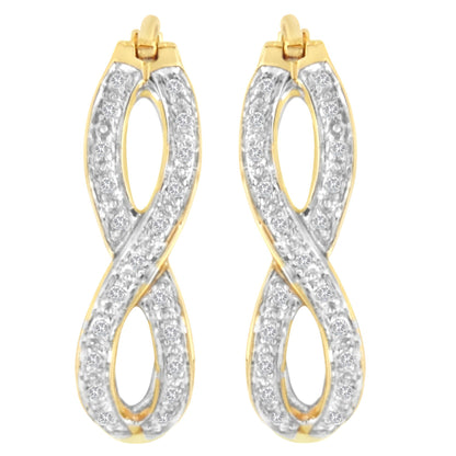 Front view of a pair of yellow metal earrings shaped in an infinity-like loop, each adorned with multiple white round gemstones in prong settings.