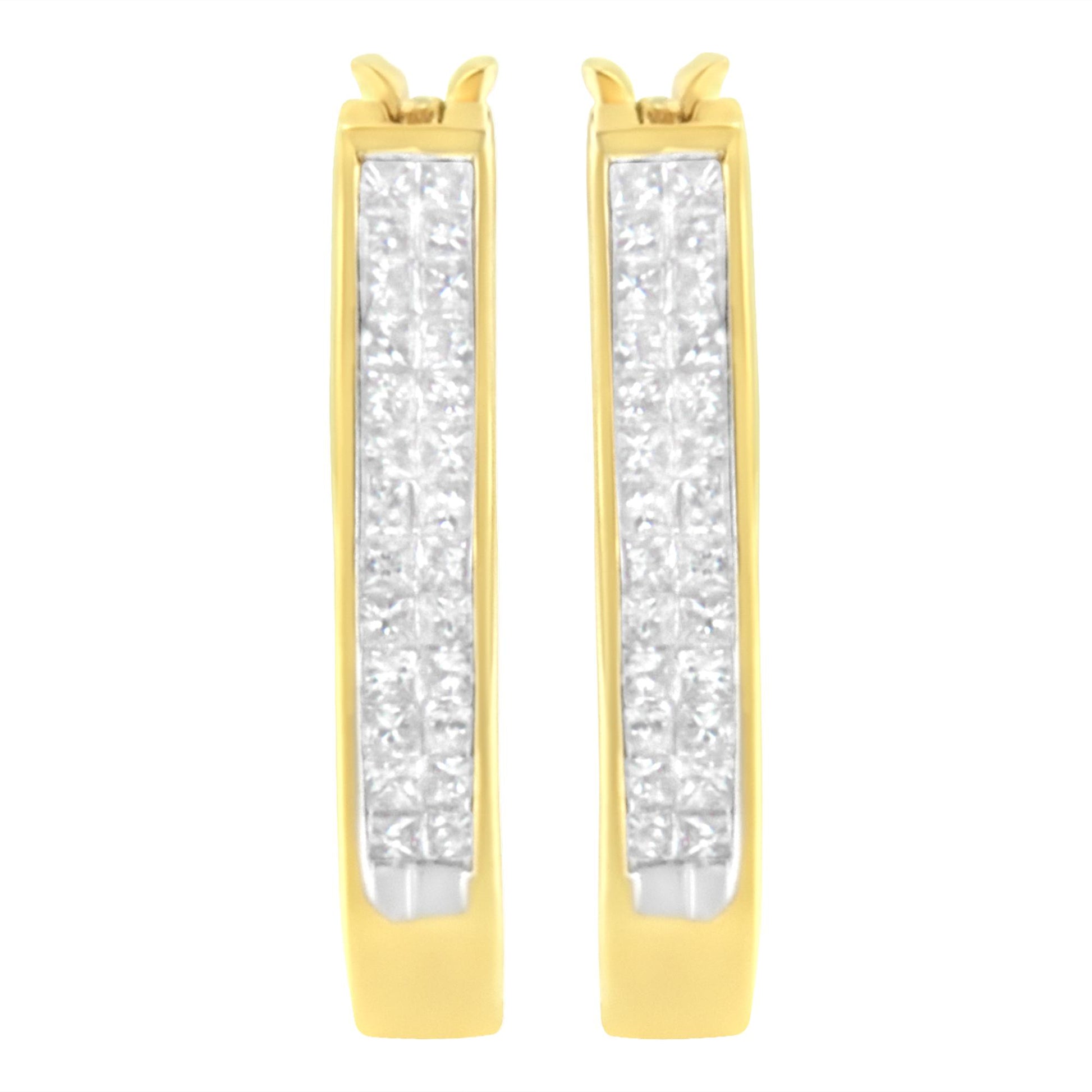 Front-facing close-up of pair of yellow metal hoop earrings with rows of white princess shape gemstones set invisibly along the front surface.
