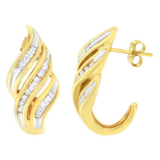 Pair of yellow metal earrings with curved, wave-like design featuring channel-set white round and baguette gemstones, shown in a close-up front and side angle.