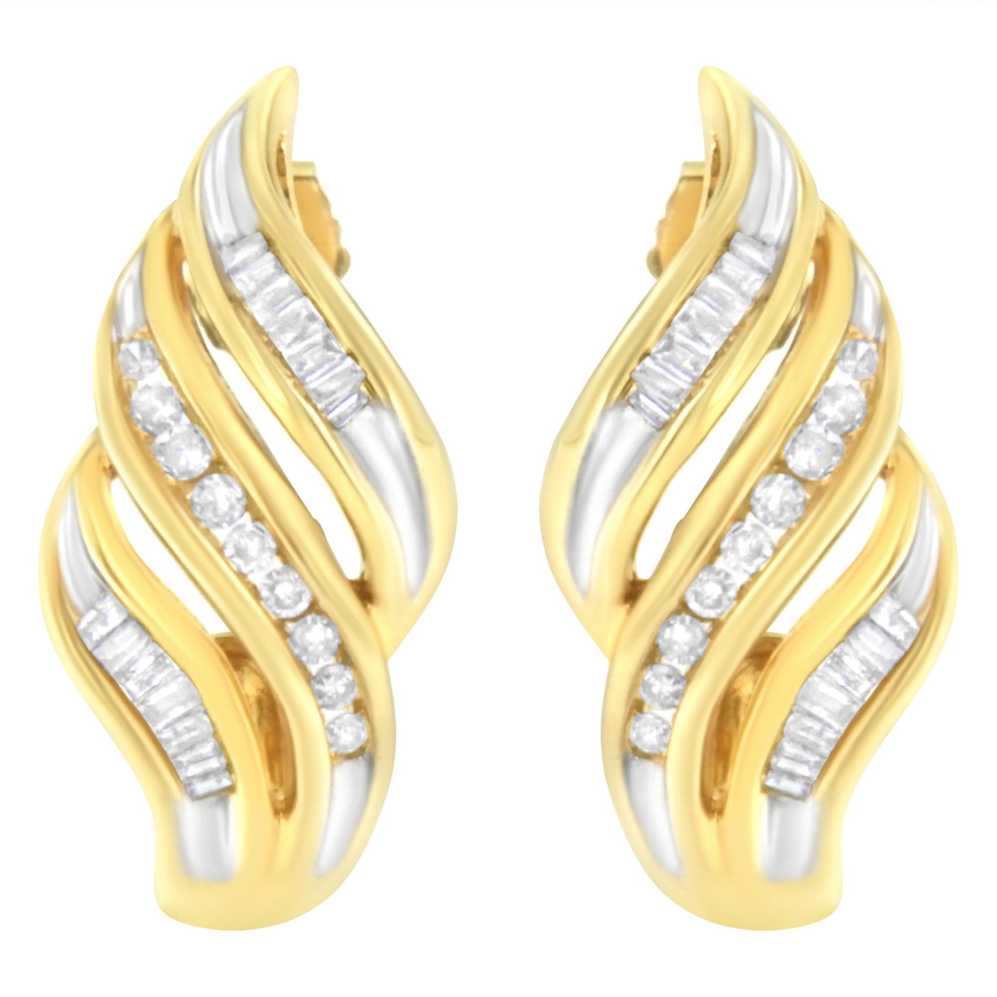 Pair of yellow metal earrings with curved design, featuring channel-set white round and baguette-shaped gemstones, shown from front angle.