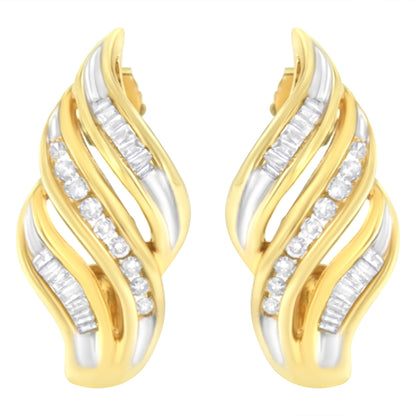 Pair of yellow metal earrings with curved design, featuring channel-set white round and baguette-shaped gemstones, shown from front angle.