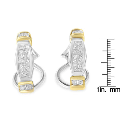 Front-facing shot of two-toned earrings with white round and princess-shaped gemstones in channel settings, shown next to a ruler for size reference.