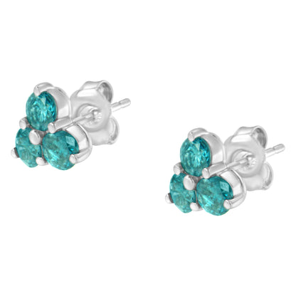 Close-up front angle of white metal earrings with three prong-set round blue gemstones each.