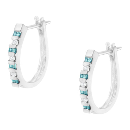 Front angled view of white metal hoop earrings featuring channel-set round white gemstones alternating with channel-set baguette blue gemstones.