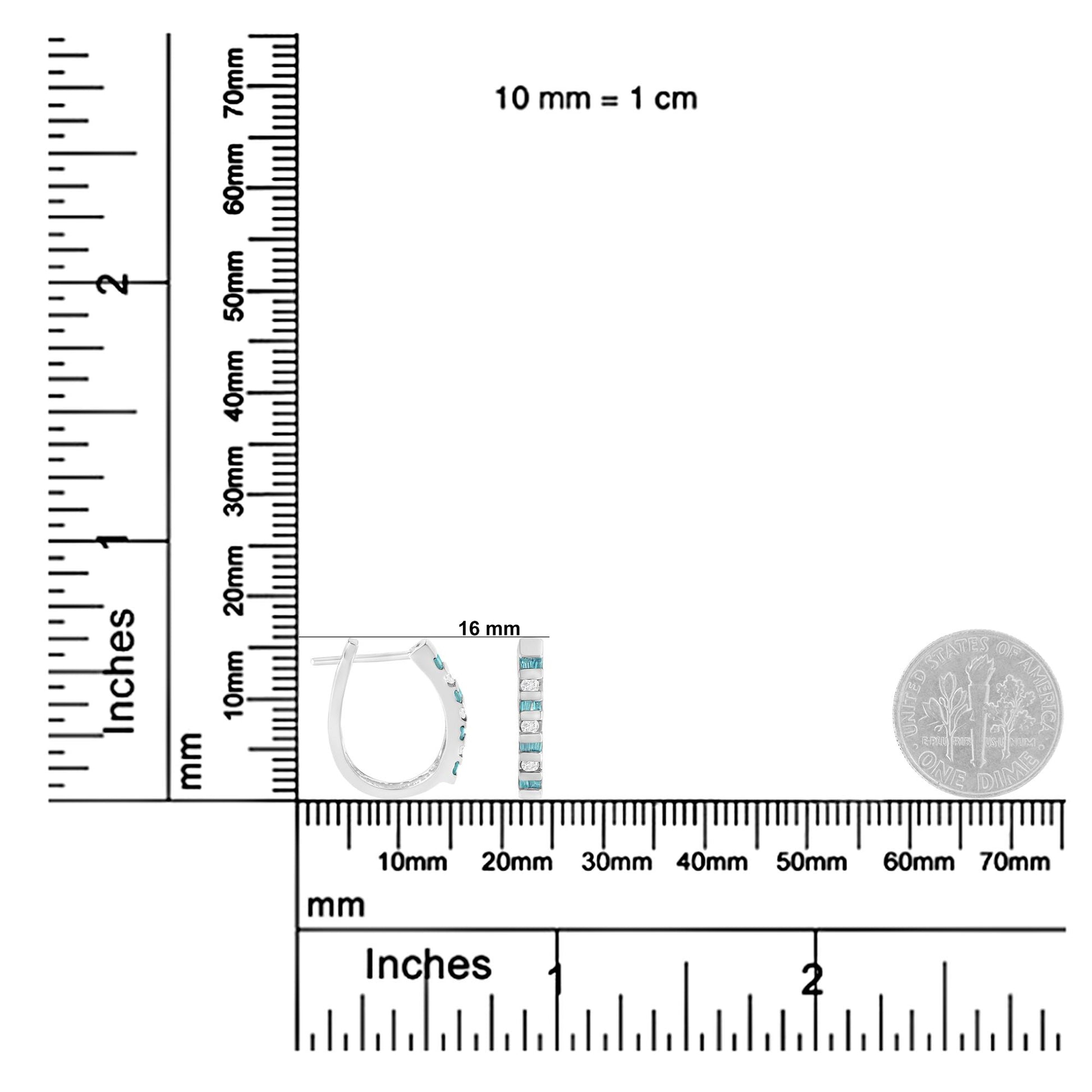 Pair of white metal earrings with round white and baguette blue gemstones in channel settings, shown from a side and front view on a ruler for size reference.