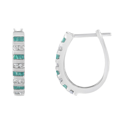 Close-up front and side view of white metal hoop earrings set with alternating rows of round white gemstones and baguette blue gemstones in channel settings.