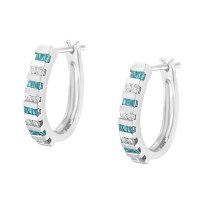 Pair of white metal hoop earrings with alternating rows of channel-set blue baguette-shaped and white round-shaped gemstones, shown from a front angled view.