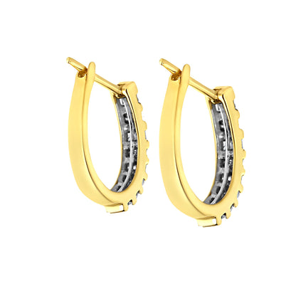 Pair of yellow metal hoop earrings with white round and baguette-shaped gemstones in channel settings, shown from a side angle.