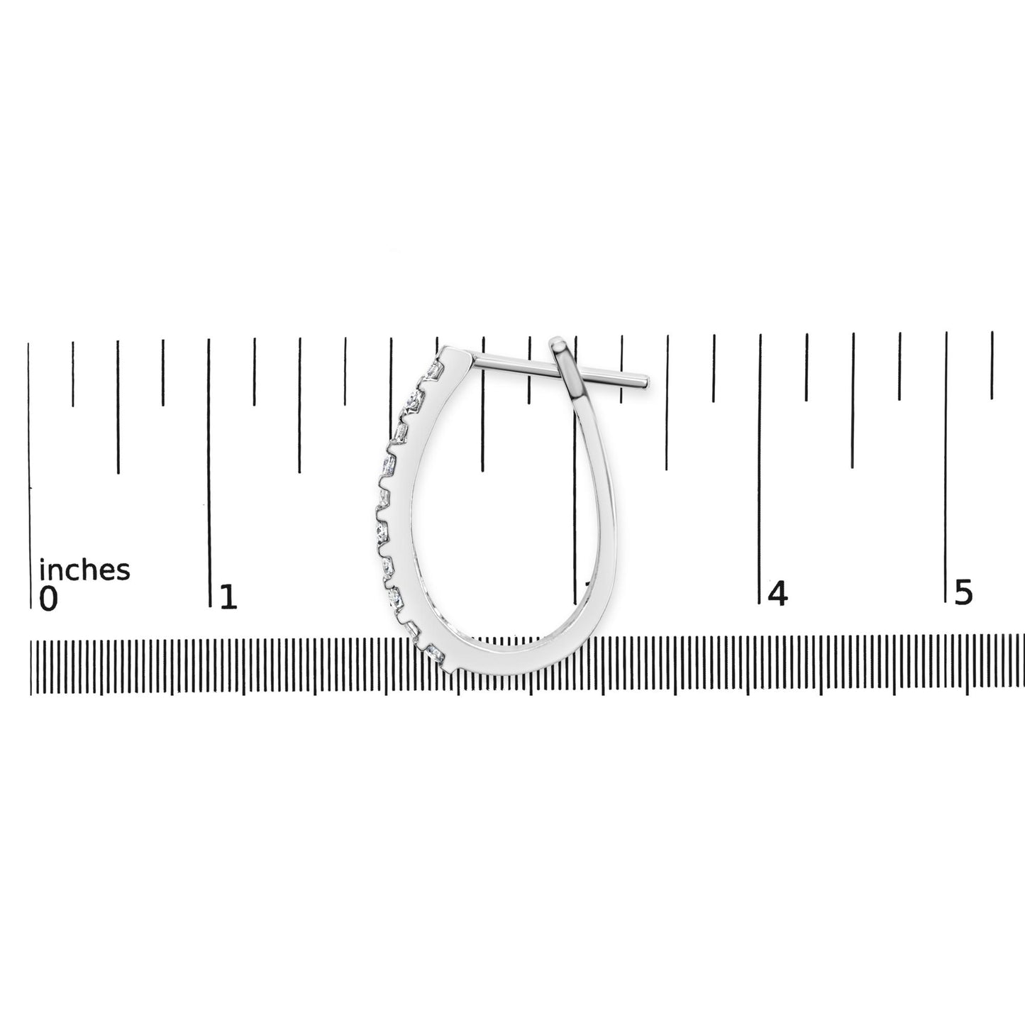 Single white metal earring with channel-set round and baguette white gemstones, displayed flat on a ruler for size reference, top-down angle.