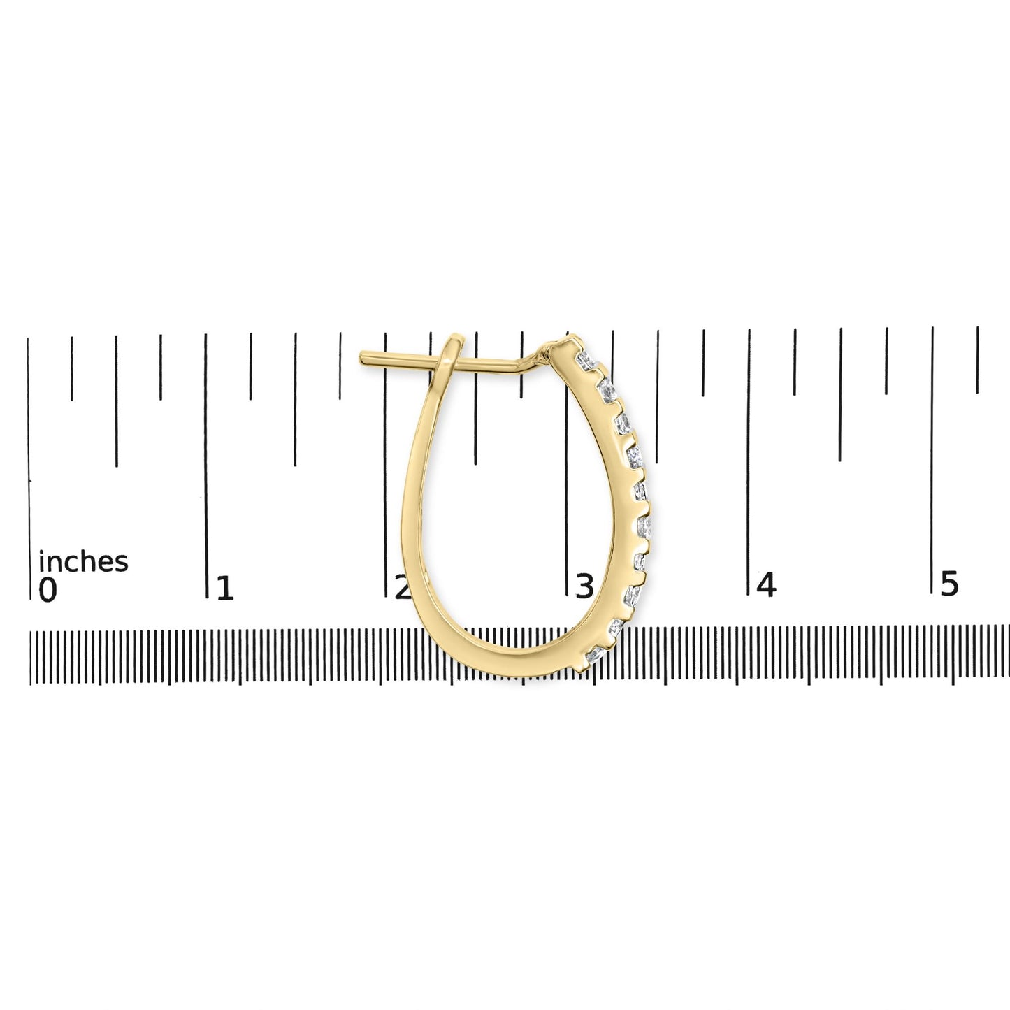 Single yellow metal earring with white round and baguette gemstones in channel setting, shown on a ruler for size reference, side view.