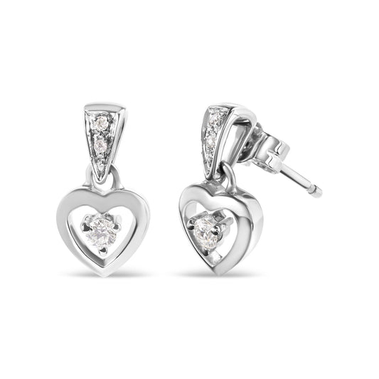 Pair of white metal heart-shaped earrings with white round gemstones in prong settings, shown from front and angled side on a white background.