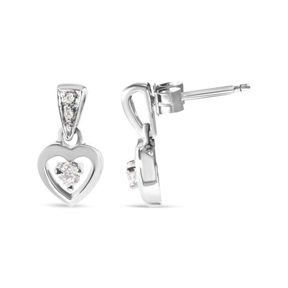Front and side view of white metal heart-shaped earrings with round white gemstones in prong settings.