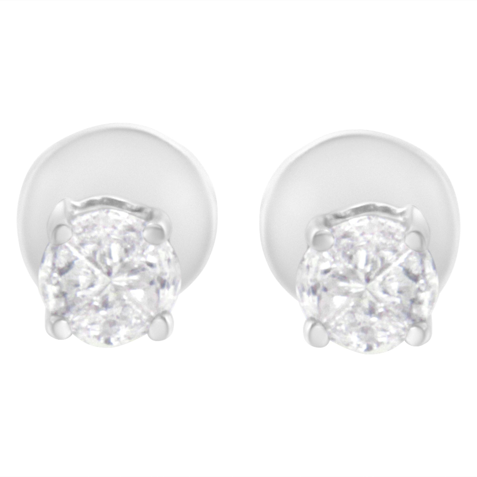 Front angle view of white metal stud earrings with round white gemstones in prong settings.