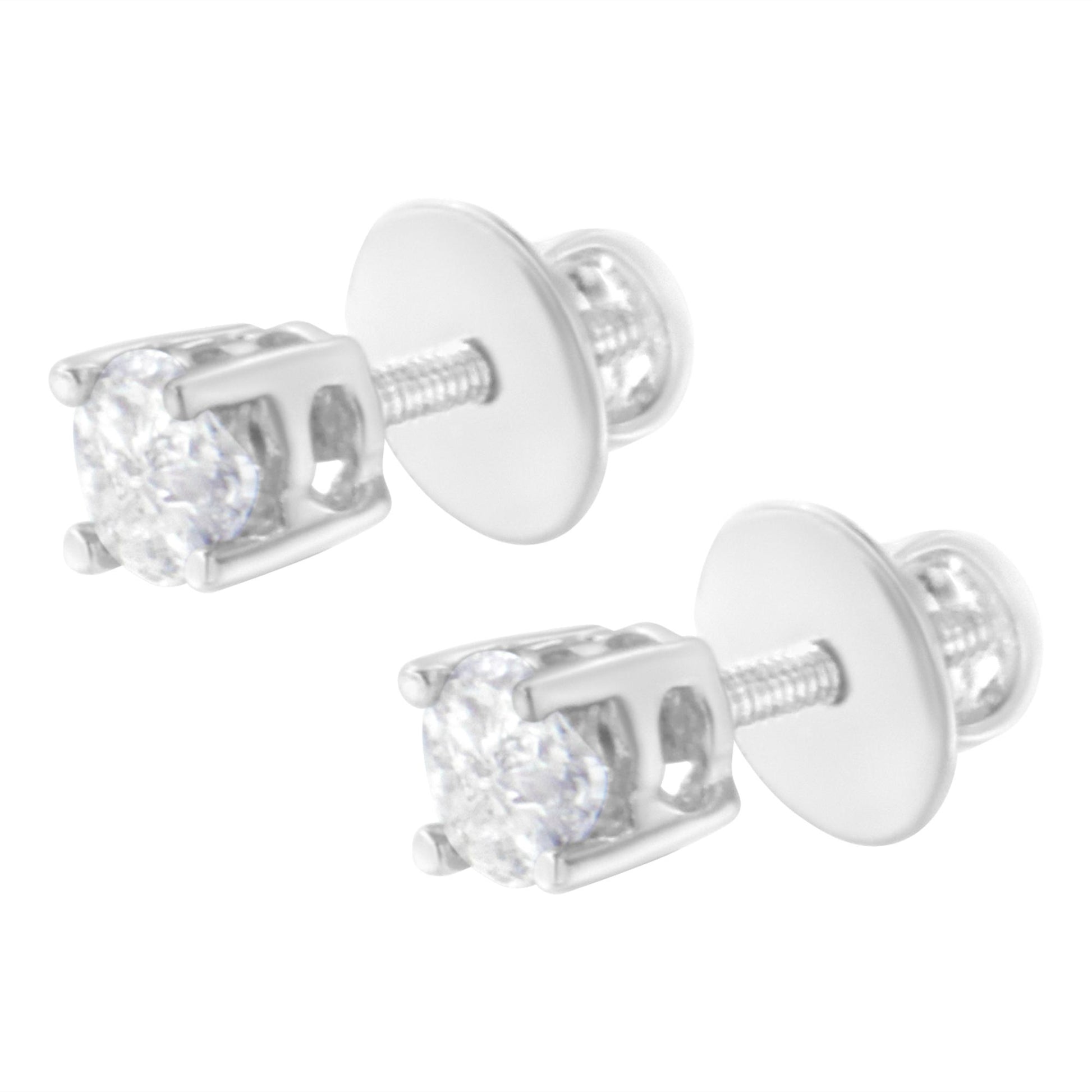 Pair of white metal stud earrings with prong-set white pie-shaped gemstones, shown in close-up angled view.