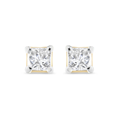 Front angle view of a pair of yellow metal stud earrings with square-shaped white gemstones held by four-prong settings.