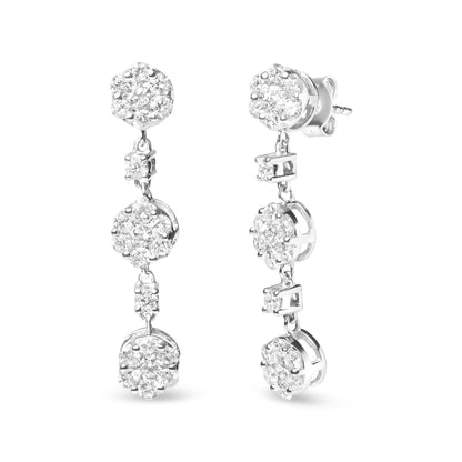 Close-up front and side view of white metal drop earrings featuring clusters of round white gemstones in prong settings.