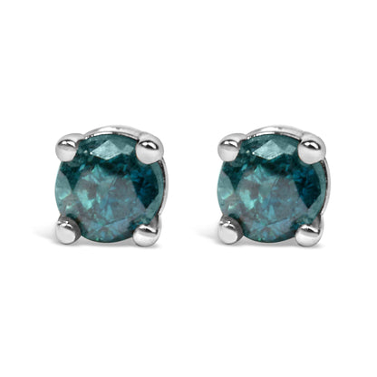 Front angled view of white metal stud earrings each set with a round blue gemstone in a prong setting.