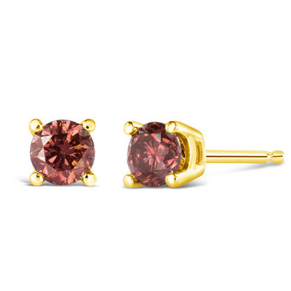 Pair of yellow metal stud earrings with round pink gemstones in four-prong settings, shown in front and side angles on a white background.