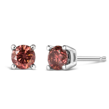 Pair of white metal stud earrings with round pink gemstones in four-prong settings, shown side by side with one facing front and the other shown at a slight angle.