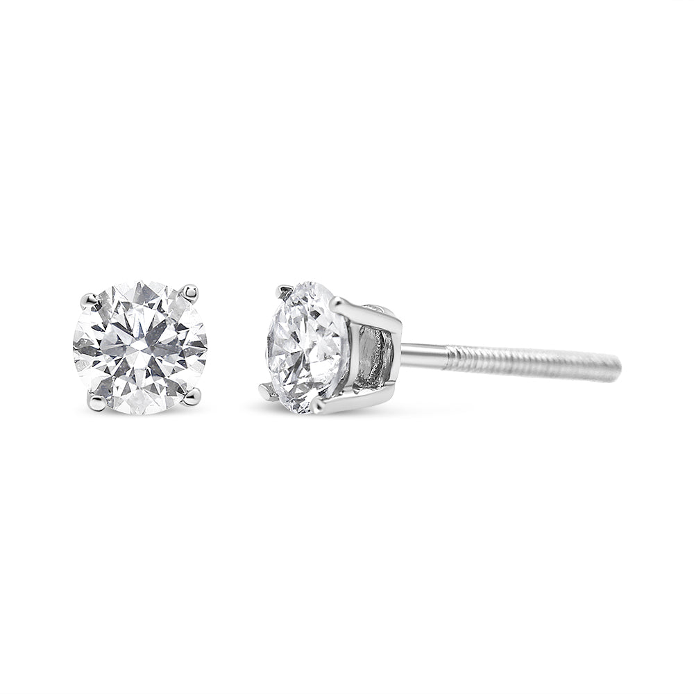 Pair of white metal stud earrings with round white gemstones in prong settings, shown from the front and side angle.