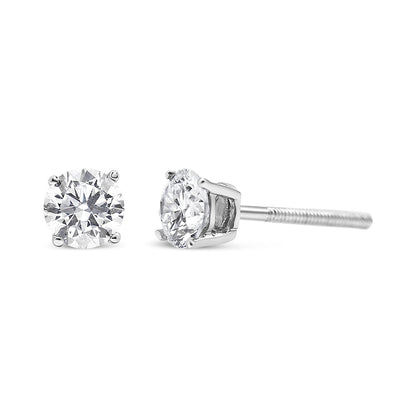 Pair of white metal stud earrings with round white gemstones in prong settings, shown from the front and side angle.
