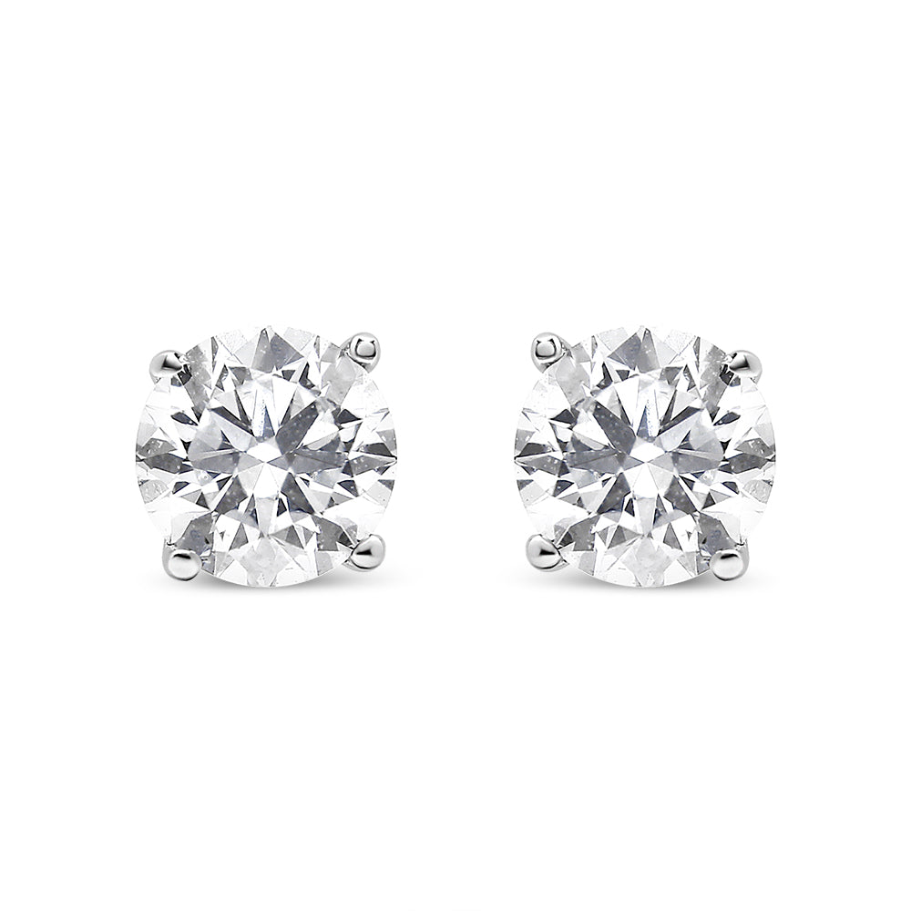 Front-facing view of a pair of white metal stud earrings featuring round white gemstones in prong settings.