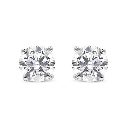 Front-facing view of a pair of white metal stud earrings featuring round white gemstones in prong settings.