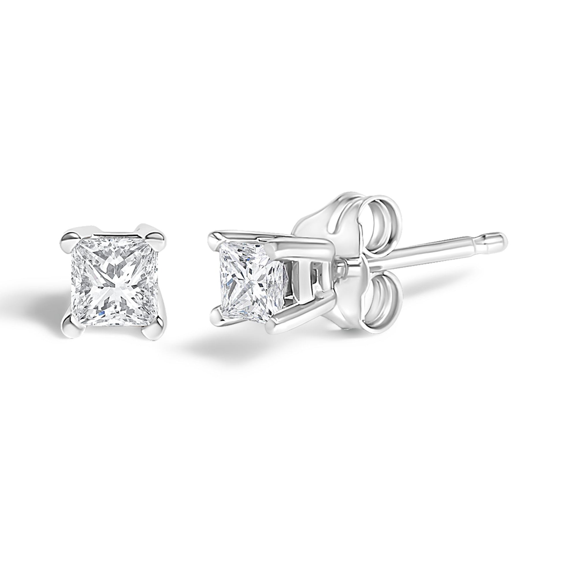 Pair of white metal stud earrings with princess-shaped white gemstones in prong settings, shown from front and side angles.