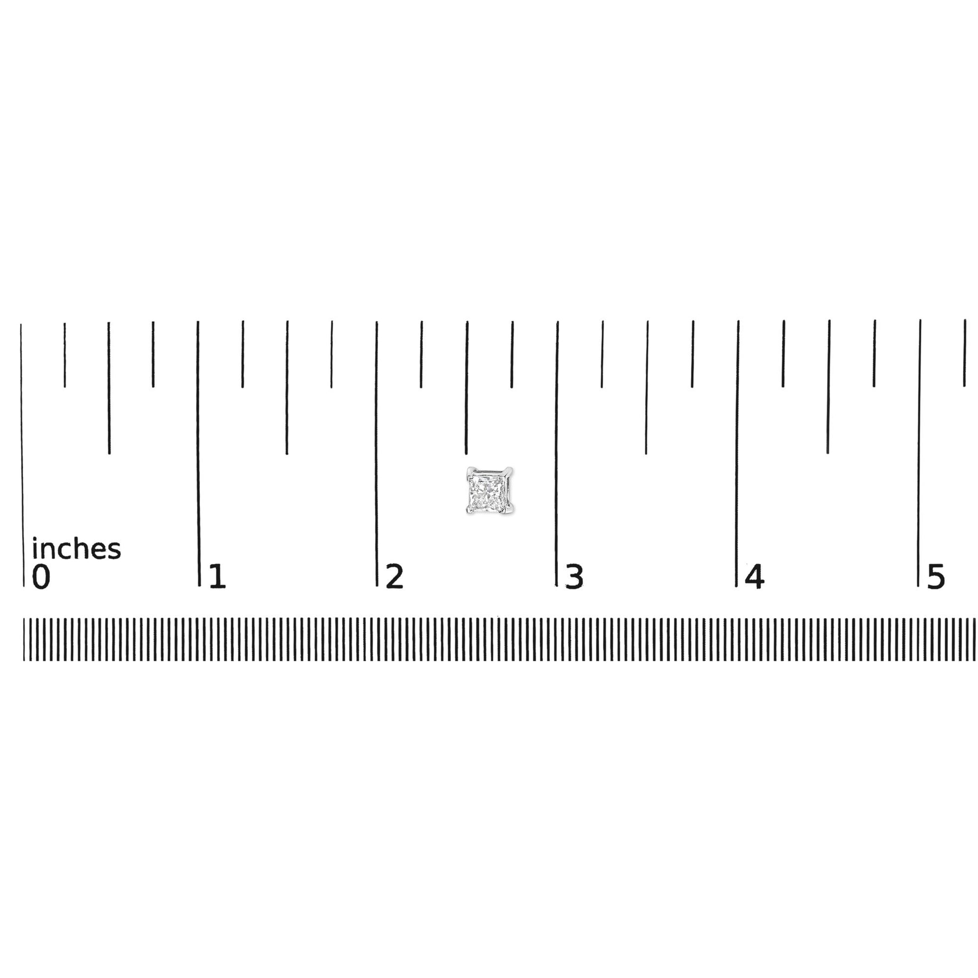 Close-up of white metal princess-shaped gemstone stud earring in a four-prong setting placed on a ruler for size reference.