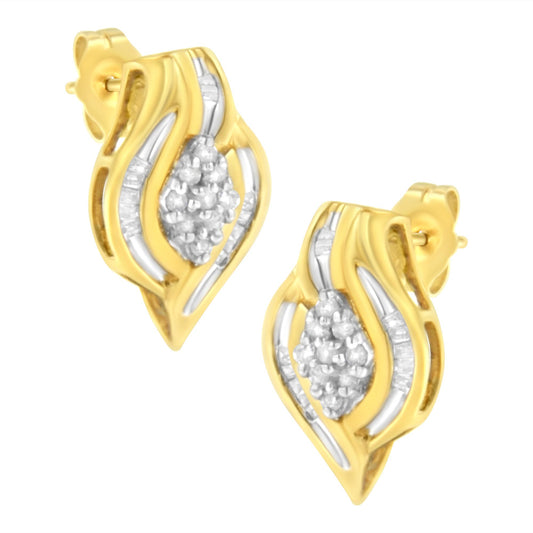 Pair of yellow metal earrings with a wavy design, featuring clustered round white gemstones in prong settings at the center and baguette white gemstones in channel settings along the sides, shown in a front angled view.