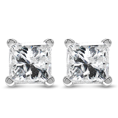Pair of white metal stud earrings with princess shape white gemstones in four-prong settings, shown in a front-facing close-up shot.
