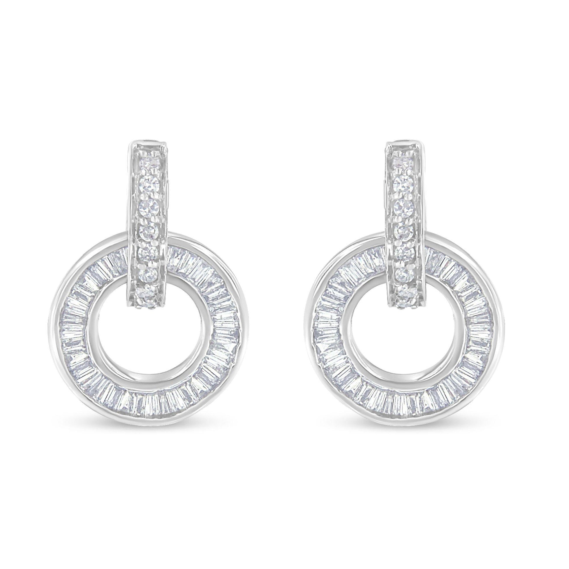 Front angle of white metal earrings with circular hoop design featuring channel-set baguette-shaped white gemstones around the hoop and prong-set round white gemstones on the hanging loop.
