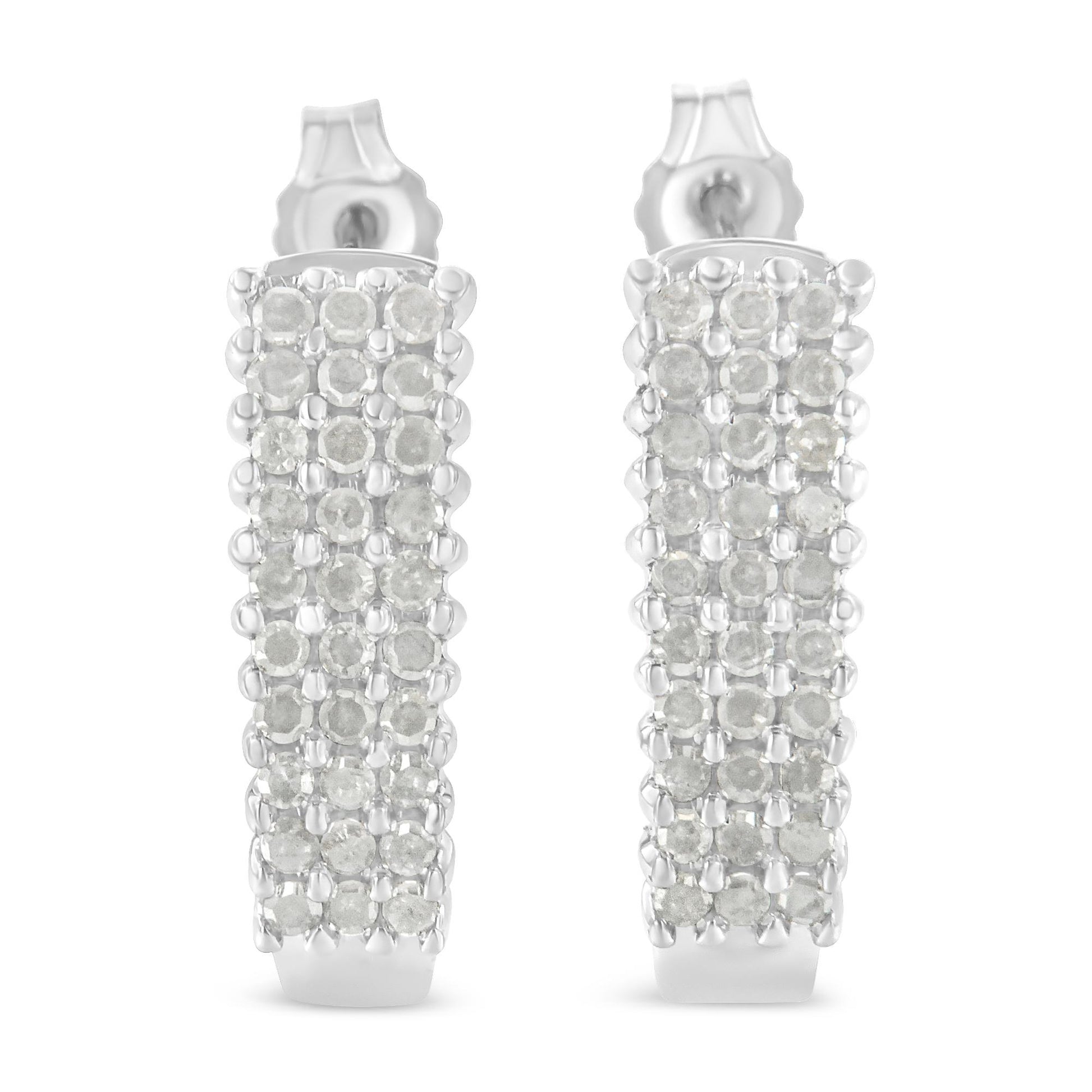 Front-facing close-up of a pair of white metal rectangular earrings set with multiple rows of round white gemstones in prong settings.