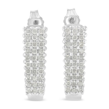 Front-facing close-up of a pair of white metal rectangular earrings set with multiple rows of round white gemstones in prong settings.