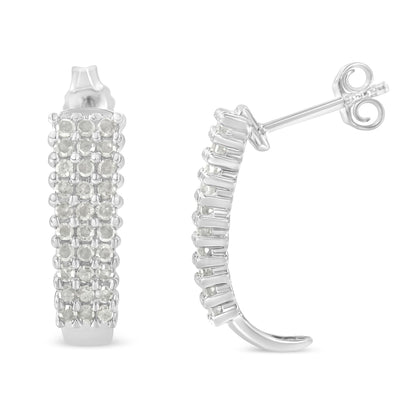 Pair of white metal semi-hoop earrings with multiple rows of round white gemstones in prong settings, shown from front and side angles.