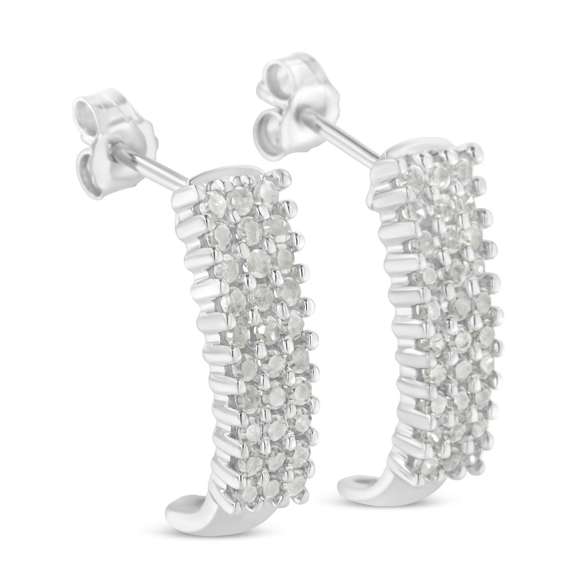 Pair of white metal earrings with rows of round white gemstones in prong settings, shown at a slight angle.