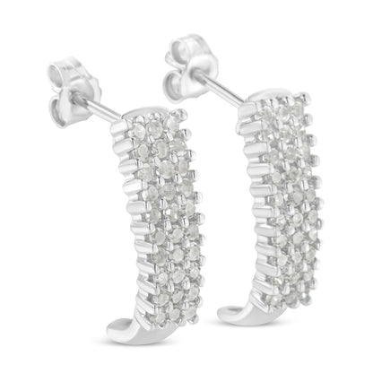 Pair of white metal earrings with rows of round white gemstones in prong settings, shown at a slight angle.