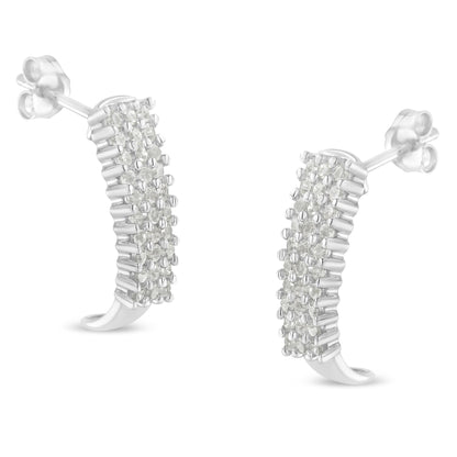 Pair of white curved stud earrings with multiple round white gemstones in prong settings, shown in a close-up front angle.