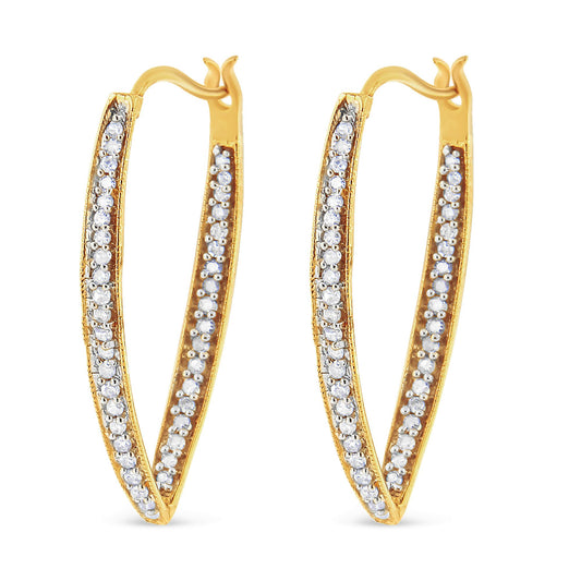 Front-facing shot of a pair of yellow metal hoop earrings with rows of round white gemstones set along the outer edges in a prong setting.